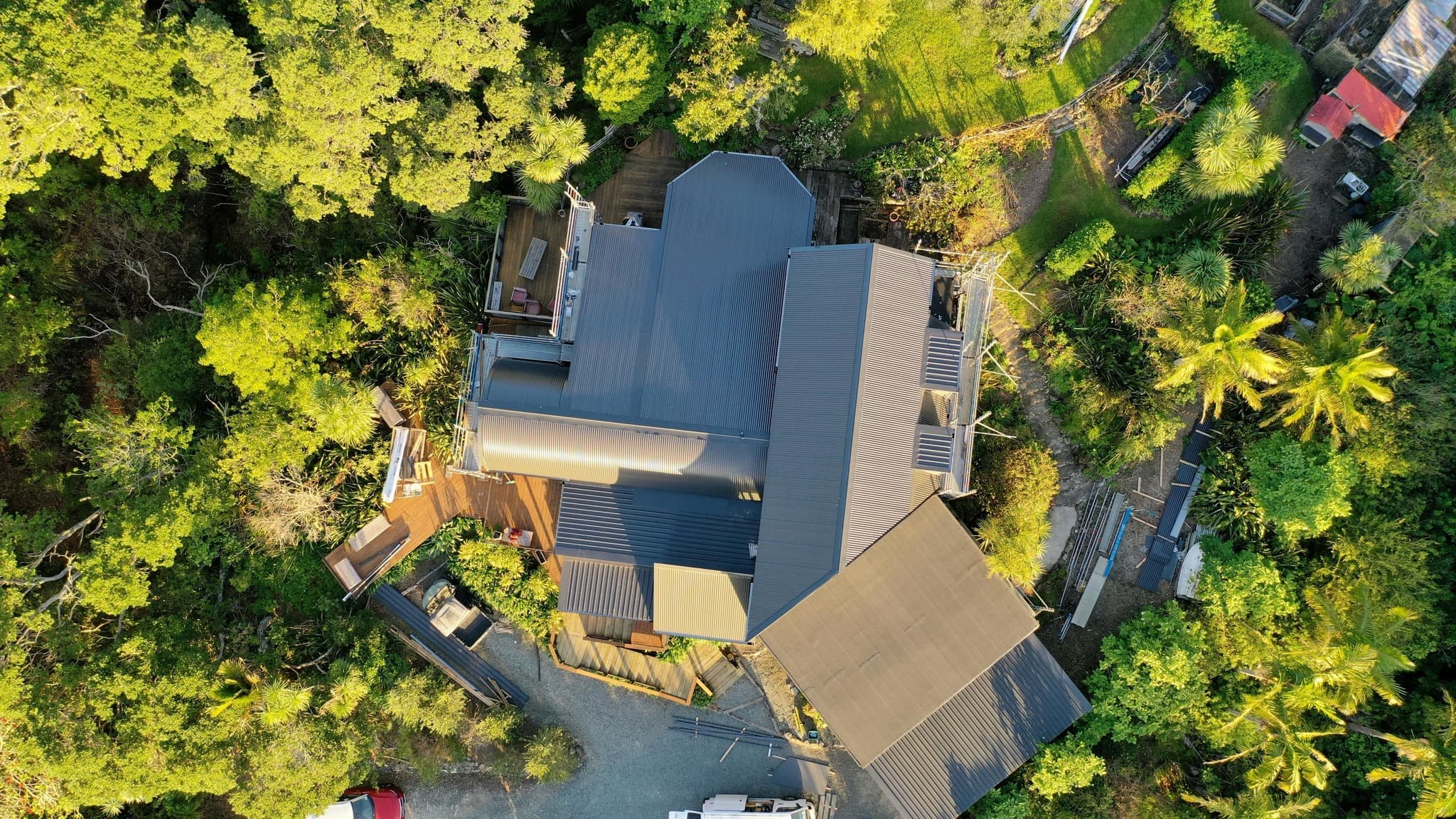 Completed metal corrugate roof installed over re-pitched structure as part of a complex re-cladding project in 2025