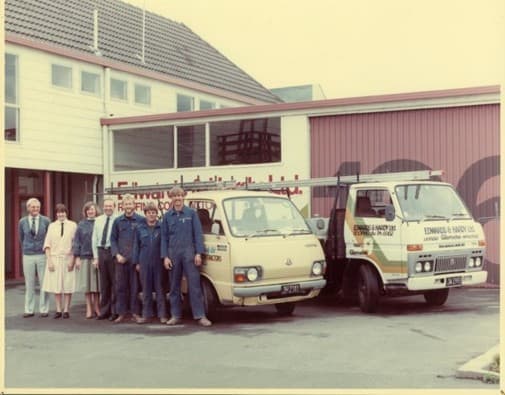The Christchurch team standing beside two Edwards & Hardy work trucks