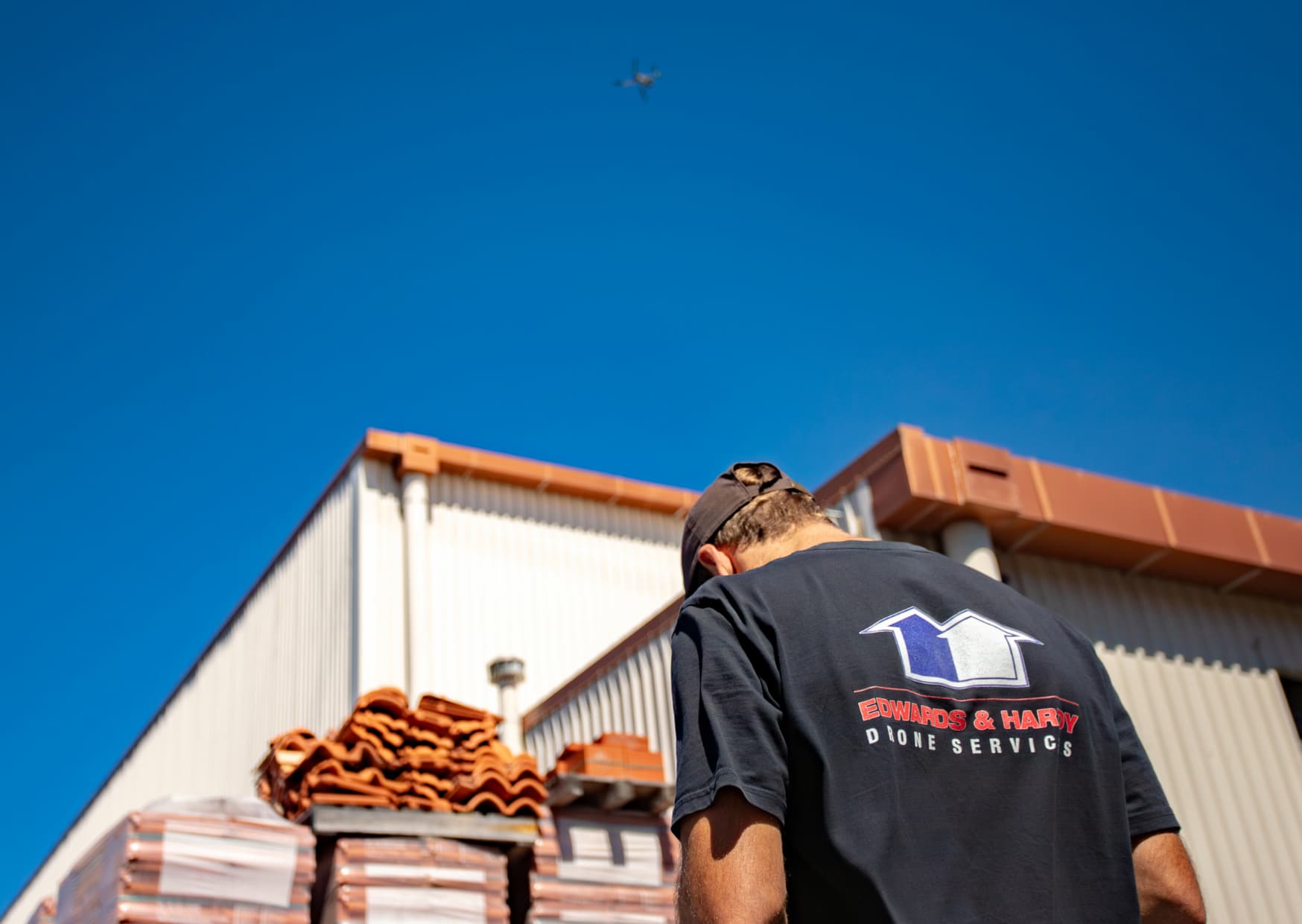 Edwards & Hardy specialist inspecting a residential roof for signs of damage and wear