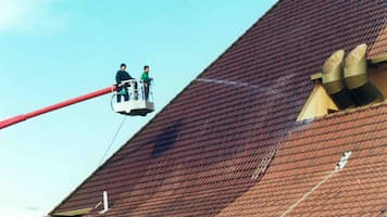 Historical Roof Cleaning a Concrete Roof from a crane cage