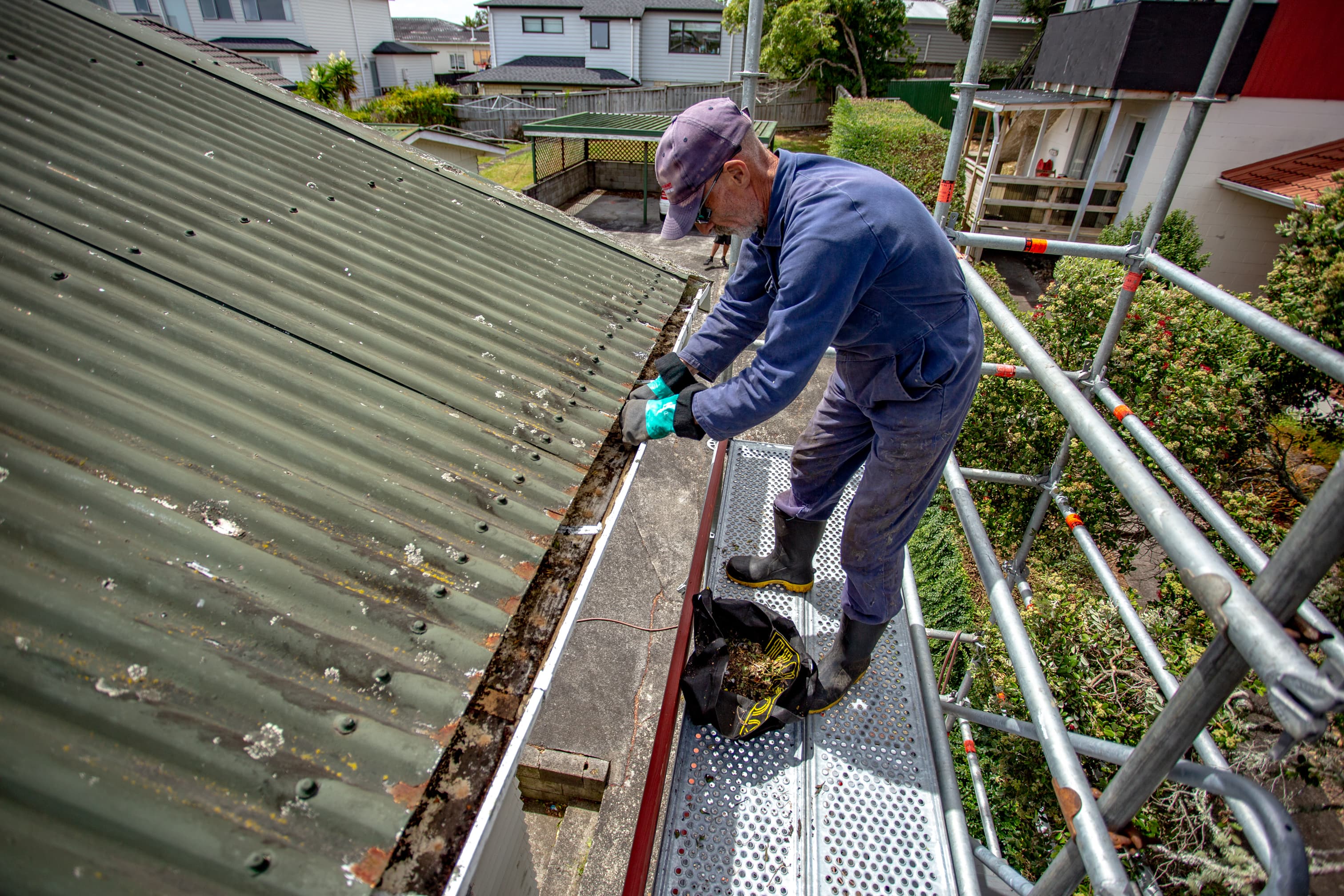 Professional gutter cleaning on scaffolding